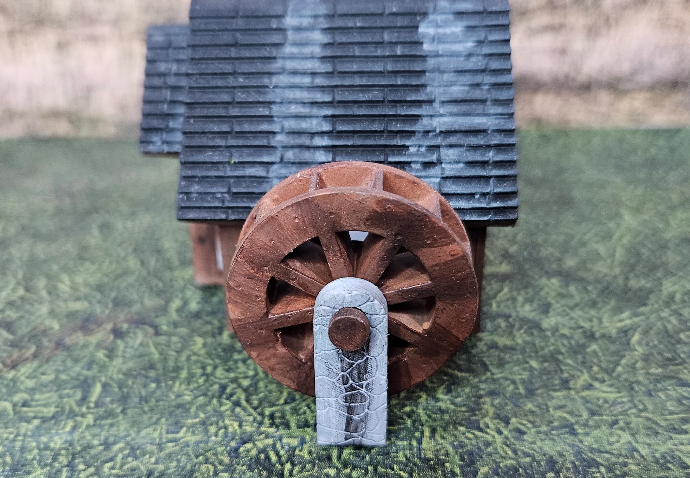 Side view of HO scale waterwheel with small building
